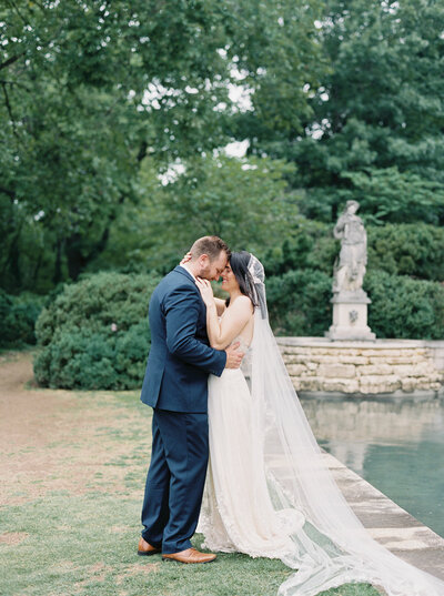 A portrait of a bride and groom holding each other