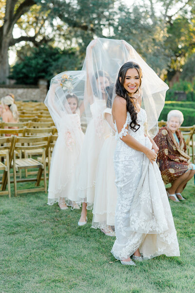 Flower girls playing under the brides veil. Boone Hall Fall wedding.