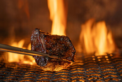 Open hearth live fire used to cook seasonal tasting menu dishes at Revé restaurant