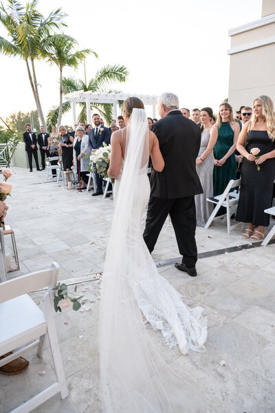 Father walking daughter down aisle at LaPlaya Beach and Golf Resort Naples