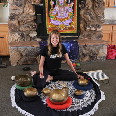 dana in front of her tibetan sound bowls for soundbath