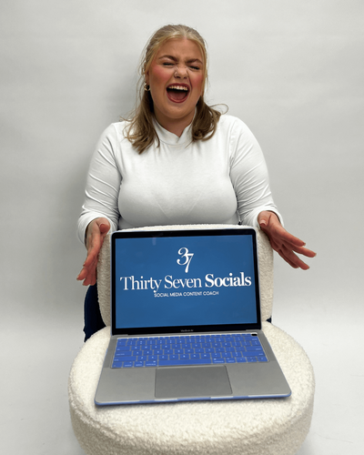 Smiling picture of a social media manager on her phone