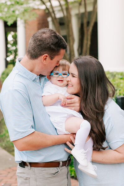 A daughter and son hug on their family lab during their family session.