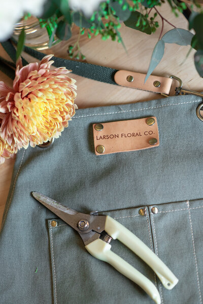 Detail shot of Larson floral co apron and sheers