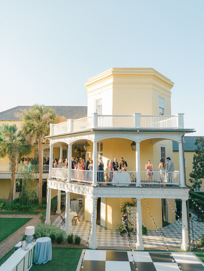 Sunset cocktail hour on the porch at William Aiken House. Fall destination wedding in Charleston.