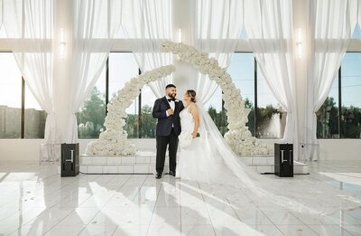 Bride and groom white floral arch