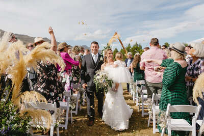 couple-walking-down-isle-at-lavender-farm-wedding