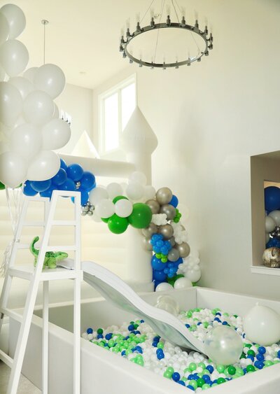 Birthday Party with green, blue and white balloons and a slide in DC