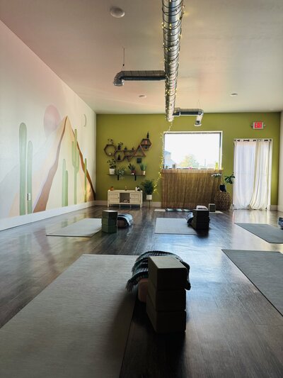 Ariane assisting a client in a yoga pose