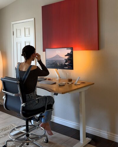 female influencer virtual assistant sitting at her standing desk