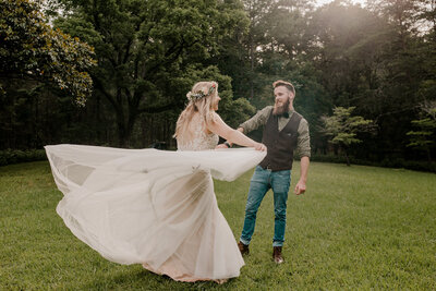 bride and groom dancing on the grass