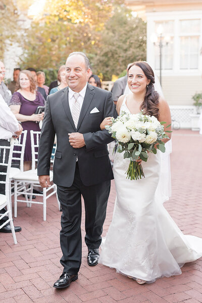 a bride walking down the aisle with her father at the vizcaya sacramento wedding venue in downtown sacramento