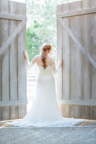 bride by gate looking over shoulder