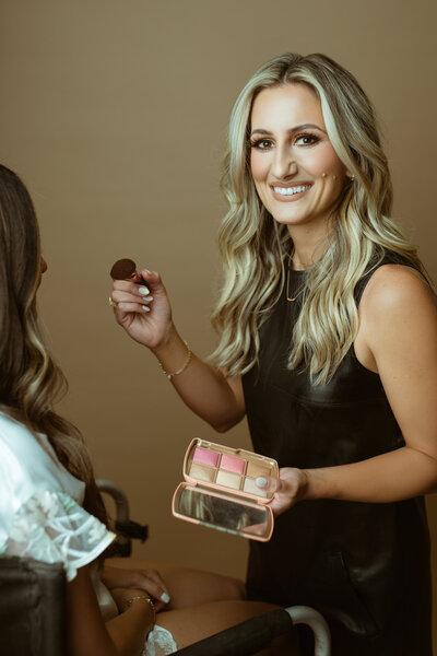 makeup artist smiling at the camera
