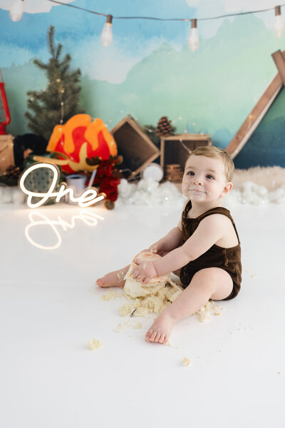 Girl in unicorn dress eating unicorn cake during themed cake smash session— captured by Alliston and Barrie cake smash photographer.