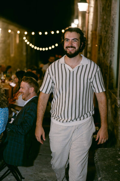 Candid picture of Brian in a striped shirt during a wedding we shot in Tuscany, Italy.