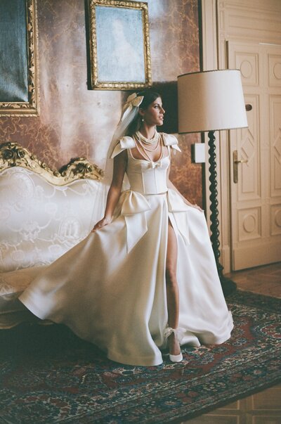 bride standing in a room while wearing her wedding dress