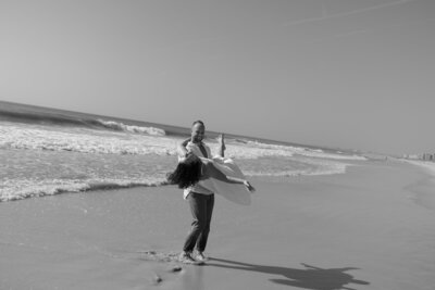 Couple playing on beach taken by Shelby Ann Photos, specializing in engagement photography florida
