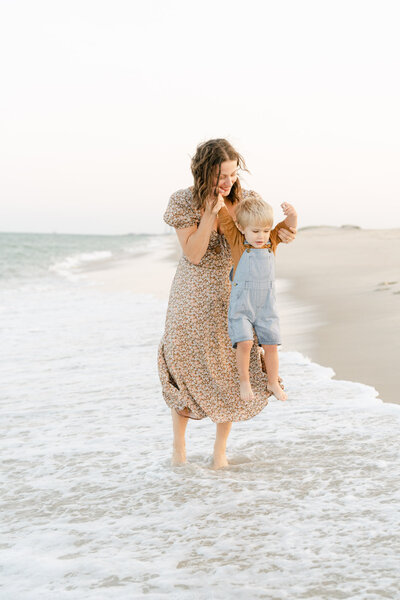 mother swings her son into the ocean at the Delaware Shore