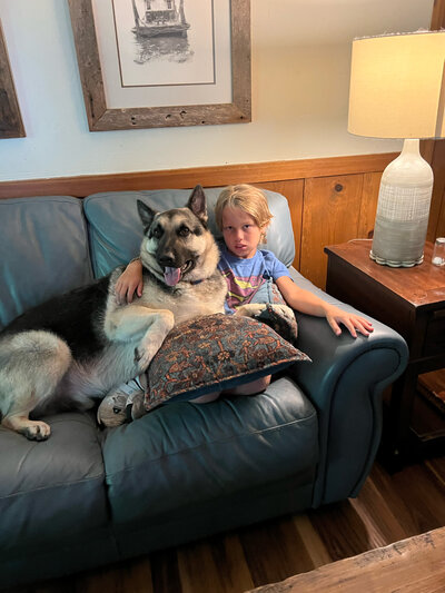 Amy's grandson Bennett with  Apollo her German Shepherd.