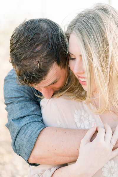 Romantic Tucson Desert Engagement Session Photo of Couple Hugging at Gates Pass | Tucson Wedding Photographer | West End Photography