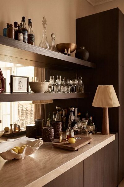 Concept image for a transitional style condo transformation, illustrating layered textures, warm tones, and eclectic styling by Sister Studio.