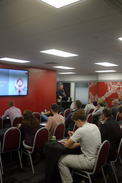 Person giving a presentation to a room of people