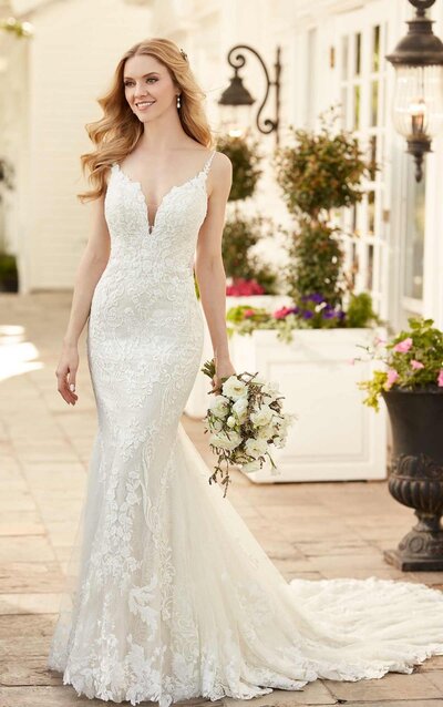 ALL-OVER LACE FIT-AND-FLARE WEDDING DRESS WITH SHEER SIDES An absolute vision in lace, this Martina Liana wedding gown is the perfect combination of sexy and formal. A column silhouette hugs the curves and flares into a mermaid-like style, with textured graphic laces creating a negative space effect over the body. Sheer side cutouts feature a hint of French-inspired laces, angled delicately over the front of the bodice and onto the back. An organic V-neckline curves into floating lace straps which then extend into a beaded multi-strap detail over the open back. Fabric-covered buttons run the length of the long, extravagant train of ornate lace details at the hem for a subtle, scalloped finish.