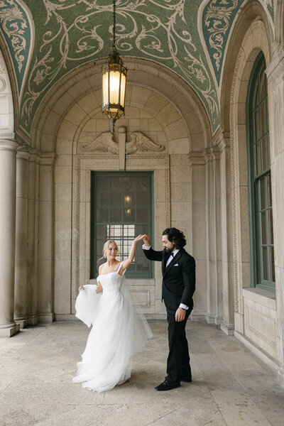 Bride twirling in her gown during romantic couple portraits, captured by a Wisconsin wedding photographer.