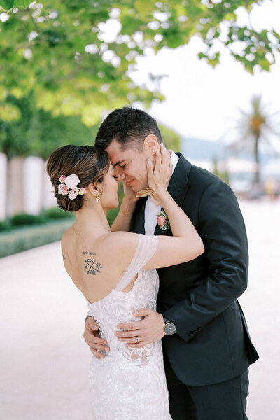 Bride and groom embracing forehead to forehead under green trees, emotional wedding moment captured by Toronto wedding photographer