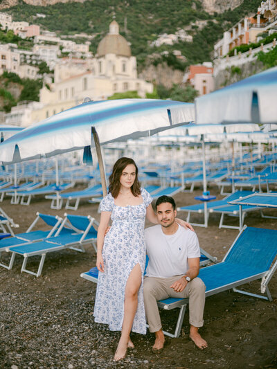 Engagement couple walking on the beach in Positano, captured by a luxury destination wedding photographer in Italy