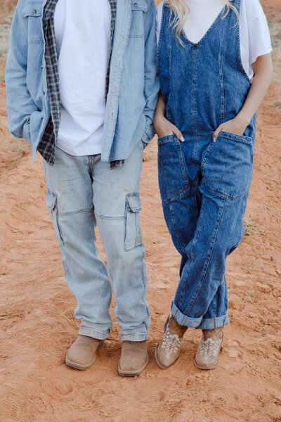 couples hands in pockets during a candid moment in Moab