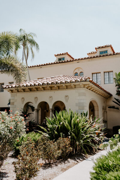 spanish style building surrounded by tropical plants
