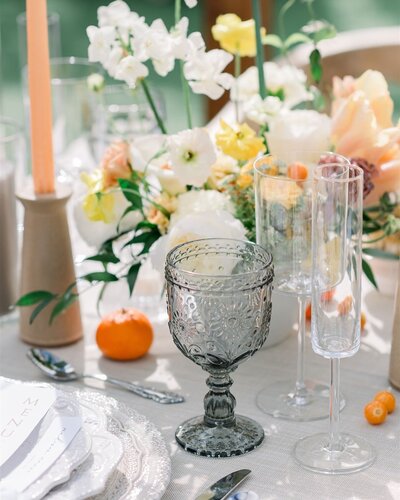Wedding reception table with butter yellow flowers and rentals at the Andaz