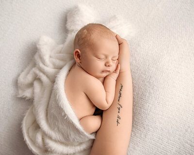 Sleeping newborn on mothers arms. OKC newborn photography