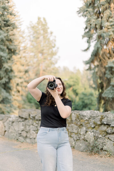 photographer sitting on the ground pretending to take a picture taken by spokane family photographer