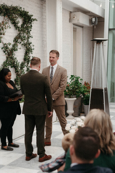 Chris reading his vows with emotion during the rooftop ceremony at Quirk Hotel in Richmond, captured in natural editorial light.