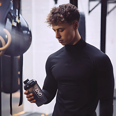 Man holding a QNT bottle – social media marketing and branding by Muse for sports and nutrition brands in Sydney