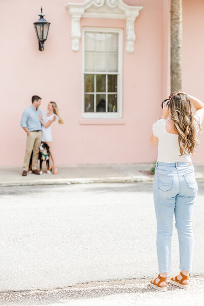 Action shot of Christina photographing a couple