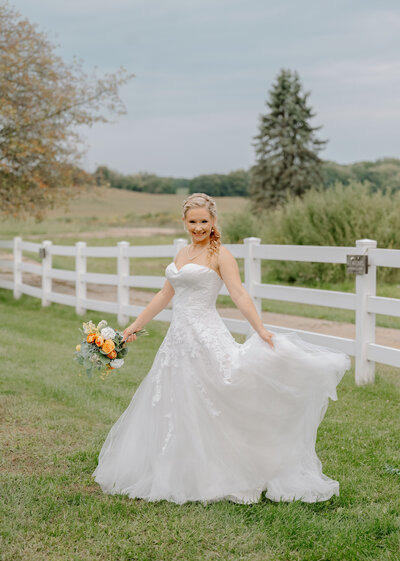 a bride twirling on her wedding day with her Michigan wedding photographer
