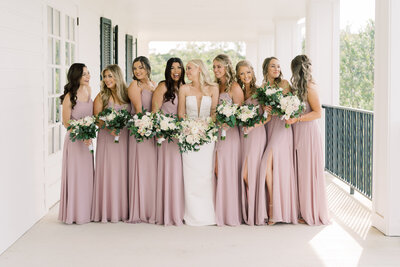 Bride and her bridesmaids posing on the porch.