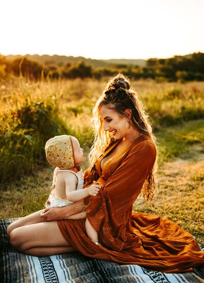 Mother and her baby daughter having a picnic photoshoot