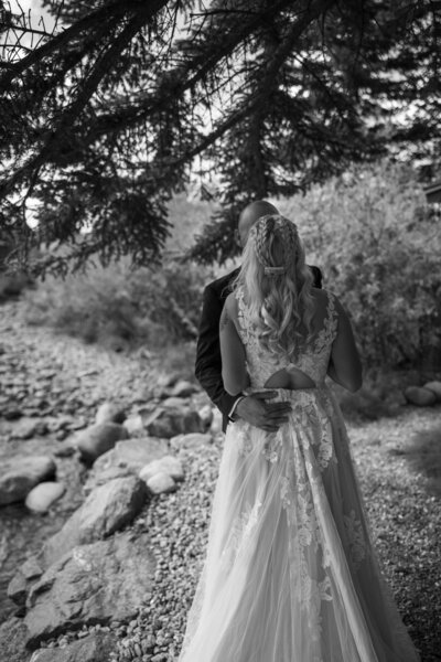 A colorado couple getting married and doing their first look in front of a mountain