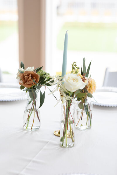 Two glass vases with flowers captured by an Austin-based wedding photographer.