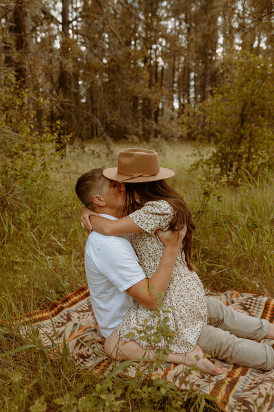 couple kissing in the forest