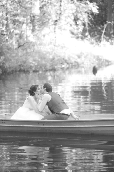 Joy of Life Events wedding planners joyful couple kisssing in row boat at The Roth Estate Weddings, Grass Valley Wedding Fair