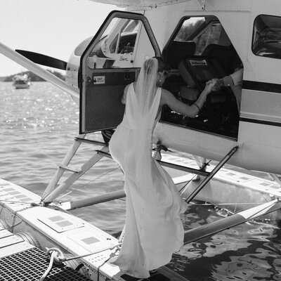 Bride climbing into float plane in wedding dress in San Juan Islands PNW