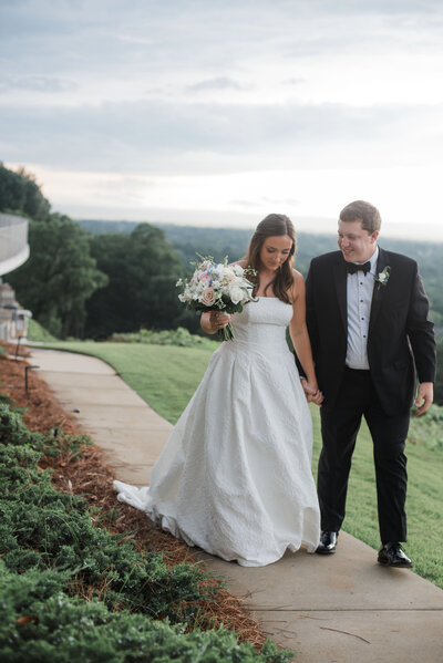 traditional bride and groom walking at The Club