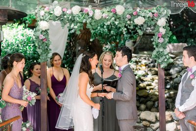 Bride laughs as she and her Groom take their vows