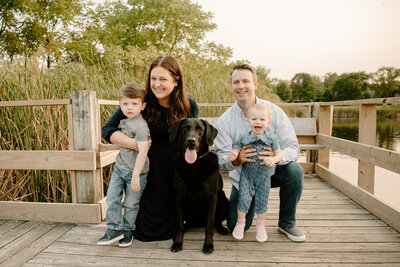 family photo with black lab dog